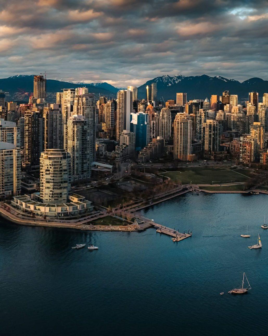 Aerial view across False Creek toward downtown Vancouver and the North Shore mountains